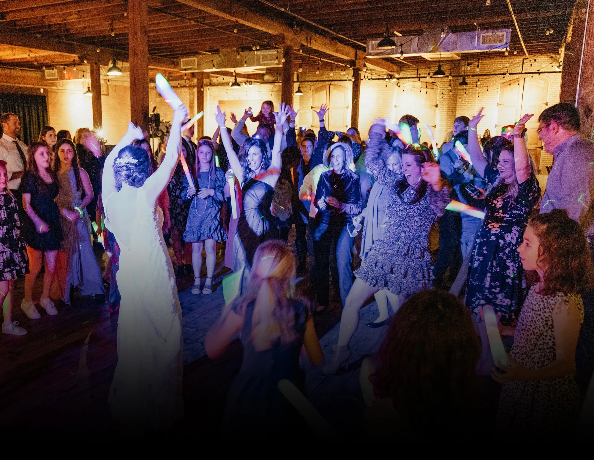 Group of happy people dancing at a wedding reception in Texas.