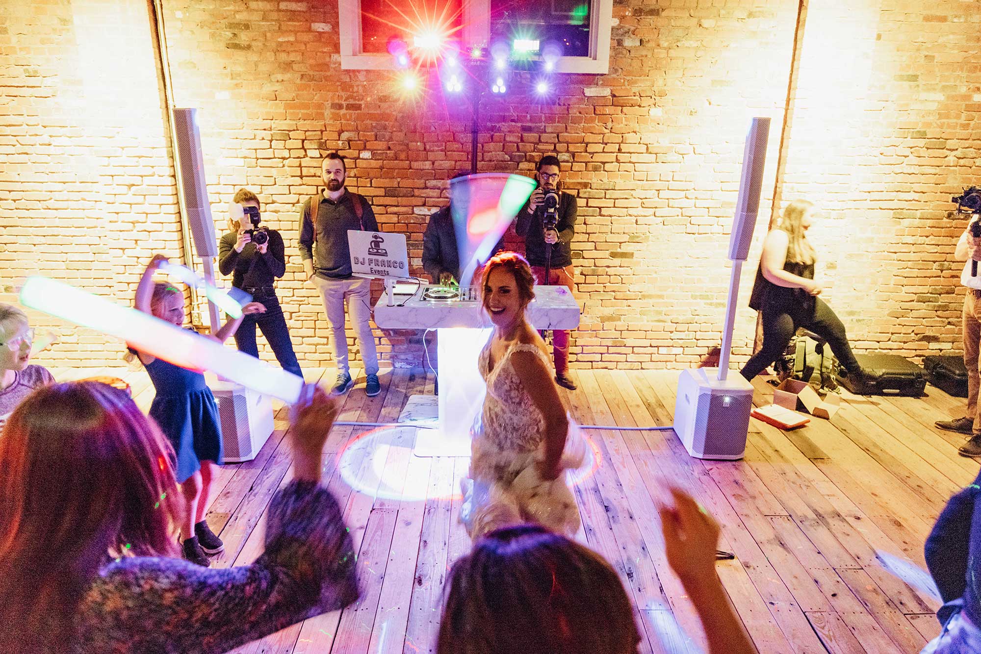 bride and guests dancing at a wedding reception